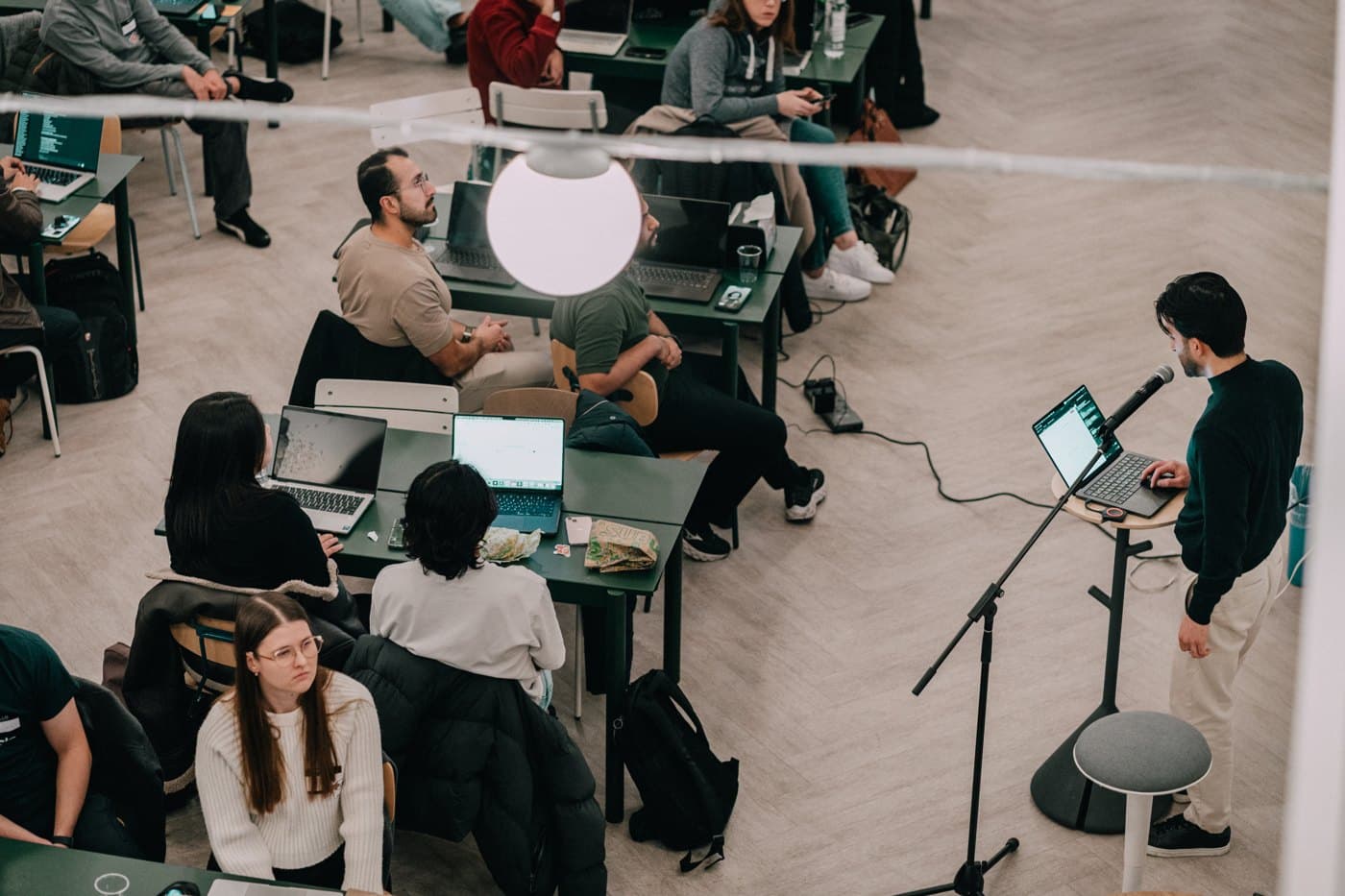 Operators working on laptops at a live AINO workshop